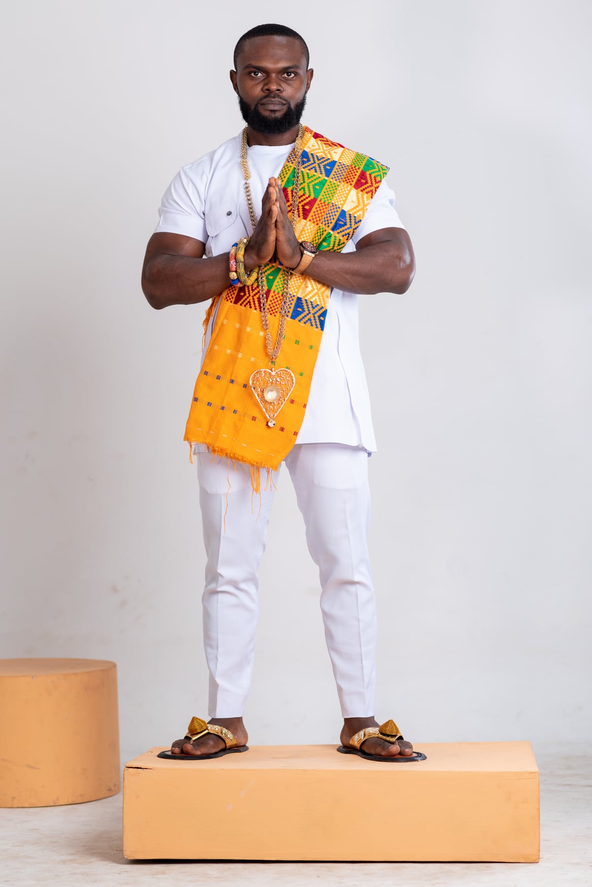 Chiwilzy in traditional attire with his hands together